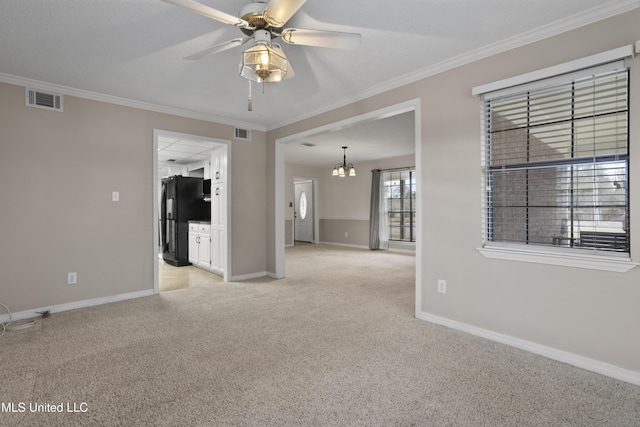 carpeted spare room featuring ornamental molding and ceiling fan with notable chandelier