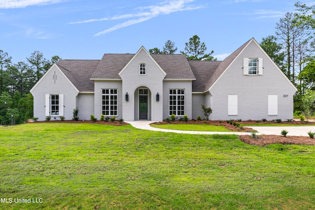 french country home with a front lawn