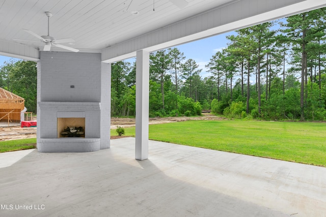 view of patio / terrace featuring an outdoor brick fireplace and ceiling fan