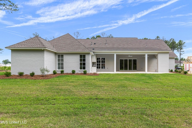 back of property featuring a yard and a patio area