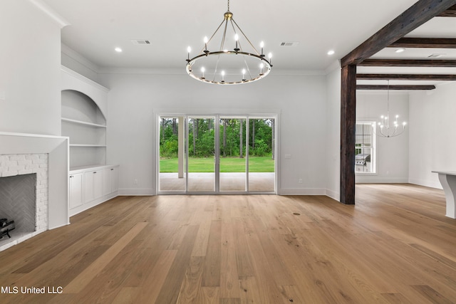 unfurnished living room featuring crown molding, beamed ceiling, light wood-type flooring, and a brick fireplace