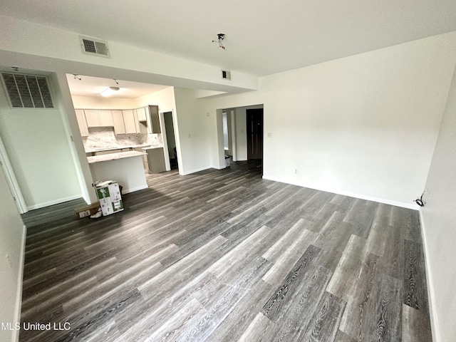 unfurnished living room featuring wood-type flooring