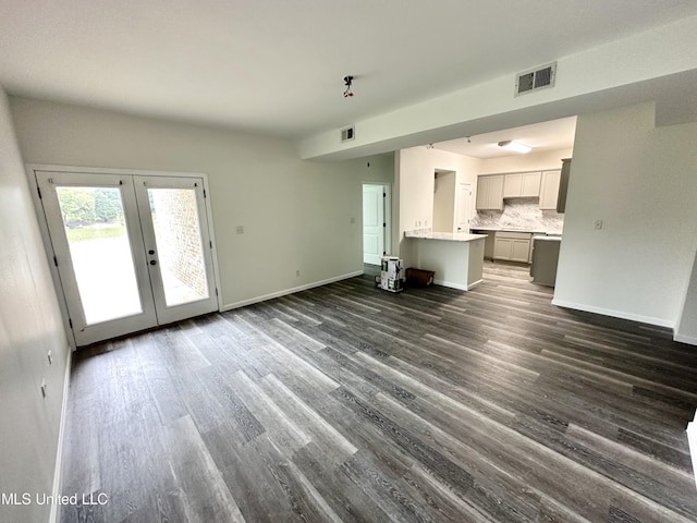 unfurnished living room with french doors and dark hardwood / wood-style floors