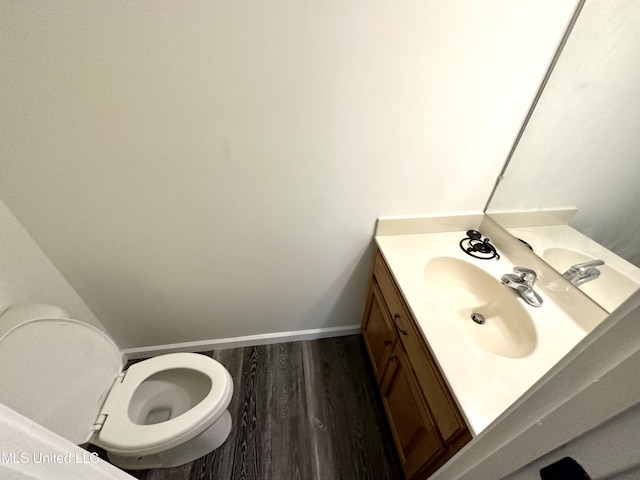 bathroom featuring hardwood / wood-style flooring, vanity, and toilet