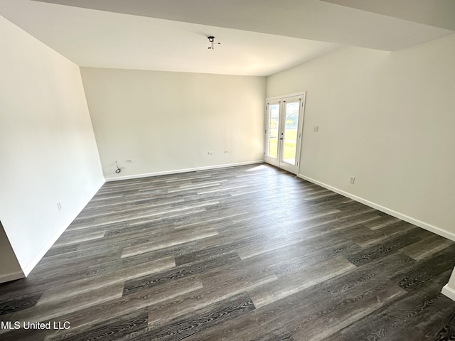 spare room with dark hardwood / wood-style floors and french doors