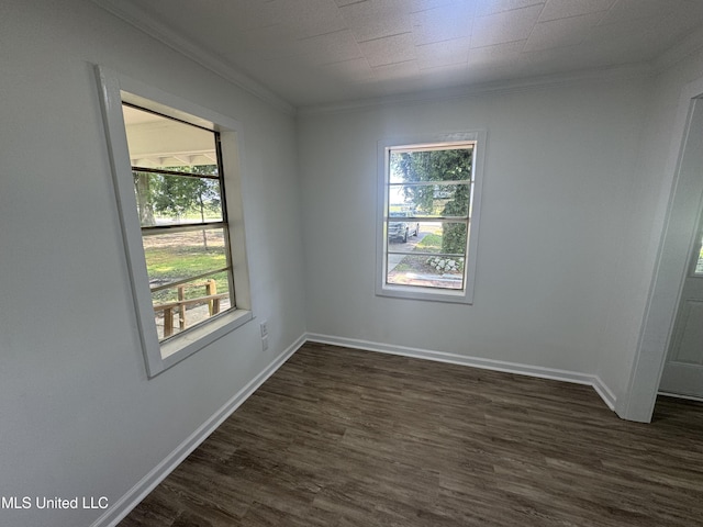 unfurnished room with crown molding, baseboards, plenty of natural light, and dark wood finished floors