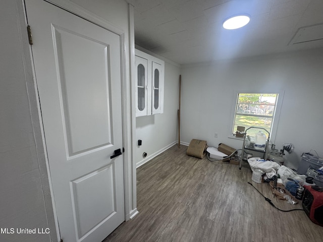 interior space with baseboards and wood finished floors