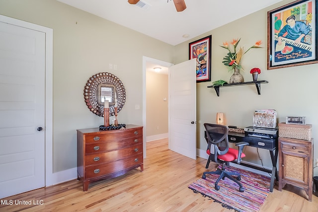 office space with light hardwood / wood-style floors and ceiling fan