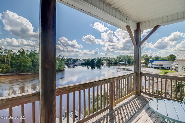 wooden deck featuring a water view