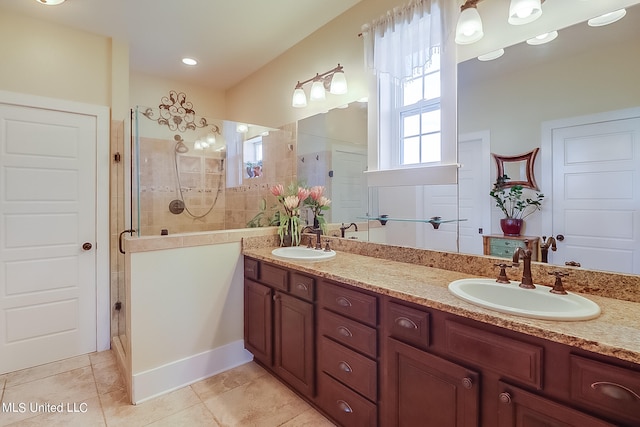 bathroom featuring a shower with door, vanity, and tile patterned floors