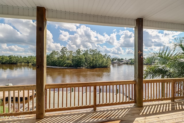 wooden terrace featuring a water view