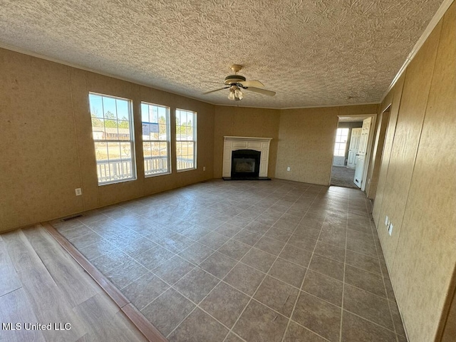 unfurnished living room featuring ceiling fan