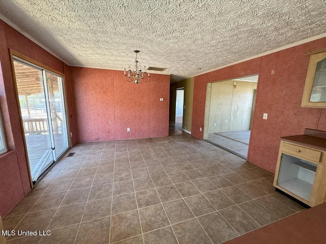 unfurnished living room featuring a chandelier, tile patterned floors, and crown molding