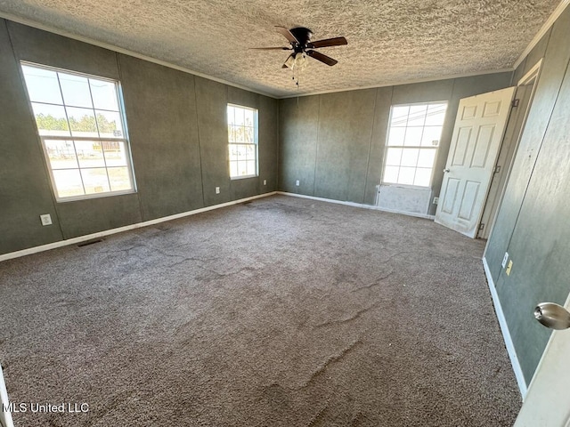 unfurnished room featuring crown molding, carpet flooring, and ceiling fan