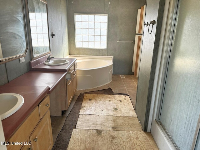 bathroom featuring a wealth of natural light, tile patterned floors, vanity, and shower with separate bathtub