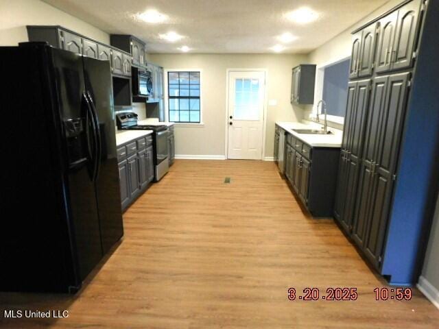 165 Christian College Rd, Senatobia, MS 38668 - kitchen featuring black appliances, a sink, light countertops, baseboards, and recessed lighting