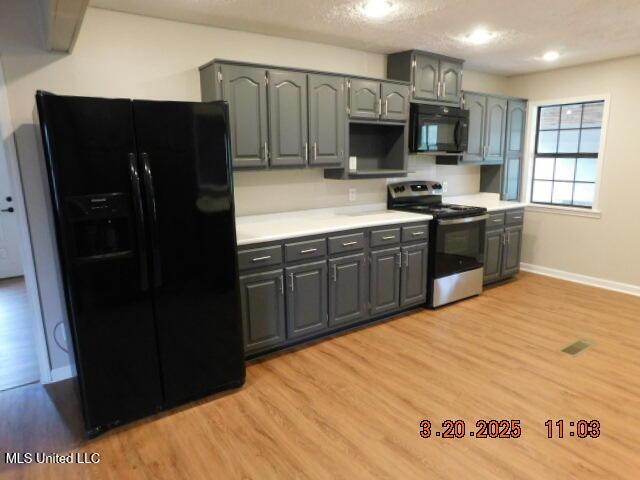 165 Christian College Rd, Senatobia, MS 38668 - kitchen featuring black appliances, gray cabinets, light wood-style floors, and light countertops