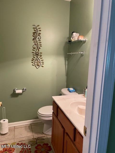 bathroom with vanity, tile patterned floors, and toilet