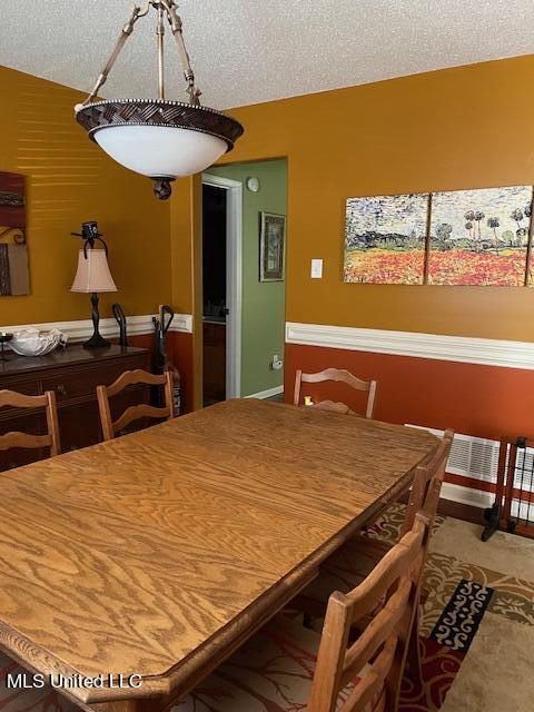 dining room with a textured ceiling