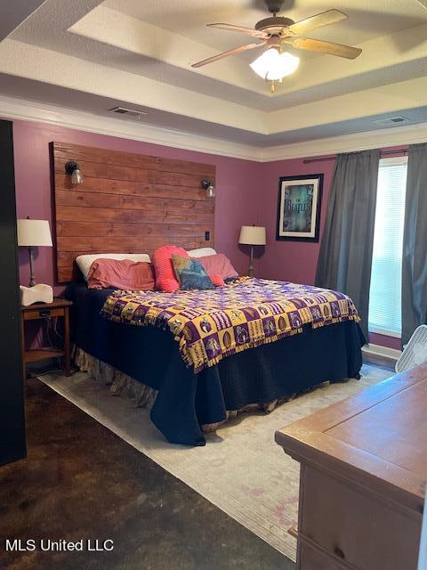 bedroom with ornamental molding, a raised ceiling, and ceiling fan