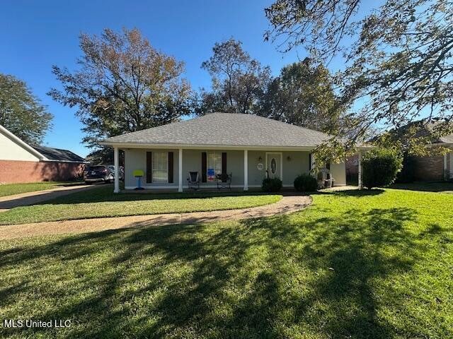 ranch-style house featuring a porch and a front lawn