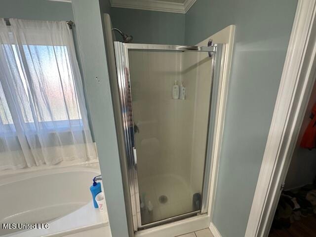 bathroom with shower with separate bathtub and crown molding