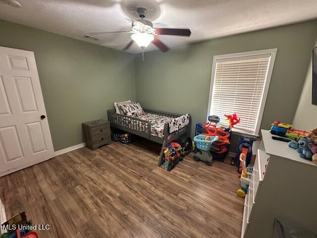 bedroom featuring hardwood / wood-style flooring and ceiling fan