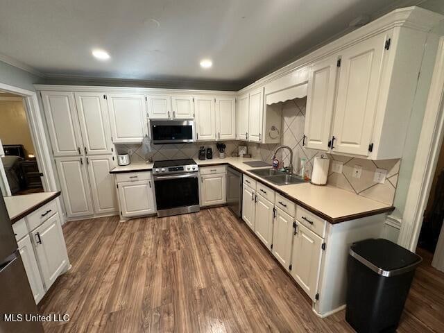 kitchen with white cabinetry, sink, and stainless steel appliances