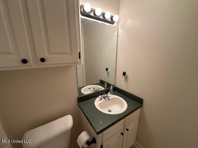 bathroom featuring vanity and toilet