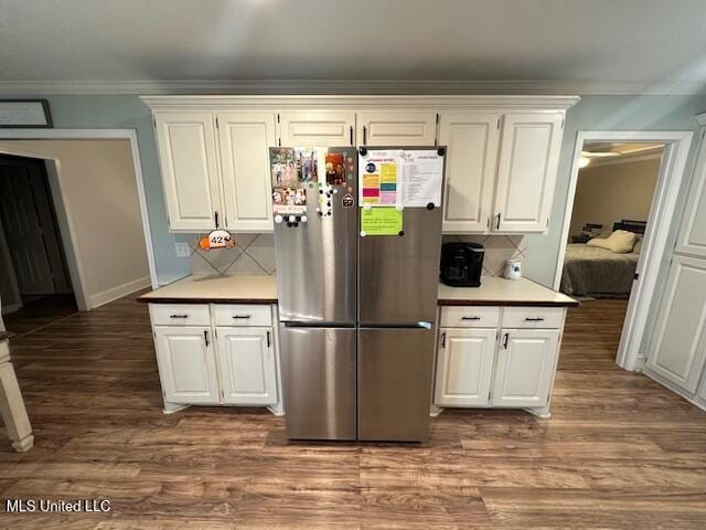 kitchen featuring stainless steel refrigerator, white cabinetry, and wood-type flooring