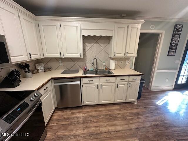 kitchen with tasteful backsplash, stainless steel appliances, sink, dark hardwood / wood-style floors, and white cabinetry