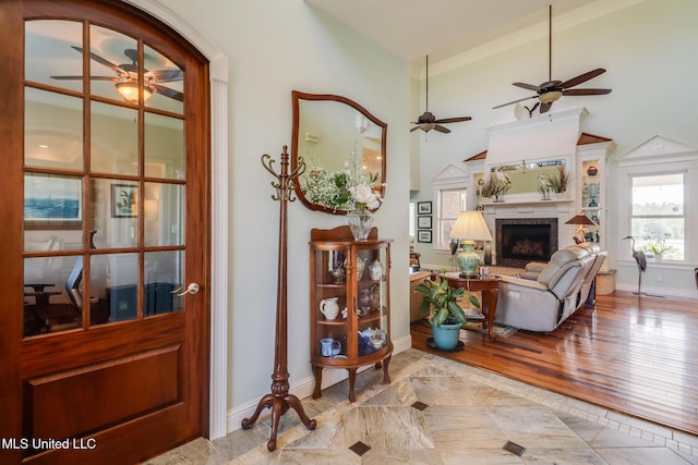 13129 Jordan Bluff Rd, Kiln, MS 39556 - living room featuring a ceiling fan, baseboards, a fireplace, and wood finished floors