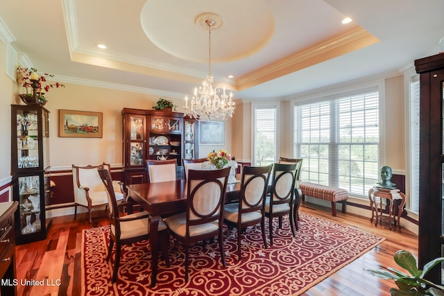 13129 Jordan Bluff Rd, Kiln, MS 39556 - dining area with a tray ceiling, a chandelier, wood finished floors, and ornamental molding