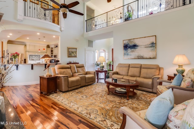 13129 Jordan Bluff Rd, Kiln, MS 39556 - living area featuring ceiling fan, wood finished floors, and a high ceiling