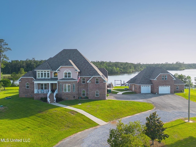 13129 Jordan Bluff Rd, Kiln, MS 39556 - traditional home featuring a water view, brick siding, a front yard, and driveway