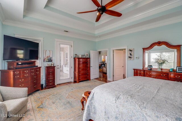 13129 Jordan Bluff Rd, Kiln, MS 39556 - bedroom with crown molding, a tray ceiling, wood finished floors, and ceiling fan