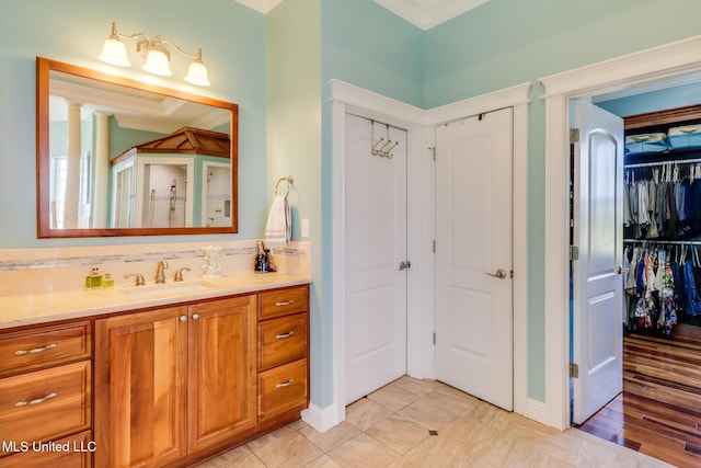 13129 Jordan Bluff Rd, Kiln, MS 39556 - full bathroom featuring vanity, ornamental molding, a spacious closet, and baseboards