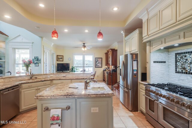 13129 Jordan Bluff Rd, Kiln, MS 39556 - kitchen featuring appliances with stainless steel finishes, cream cabinetry, a sink, recessed lighting, and crown molding