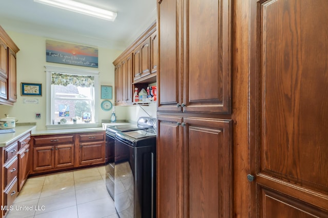 13129 Jordan Bluff Rd, Kiln, MS 39556 - laundry room featuring cabinet space, washing machine and dryer, and light tile patterned flooring