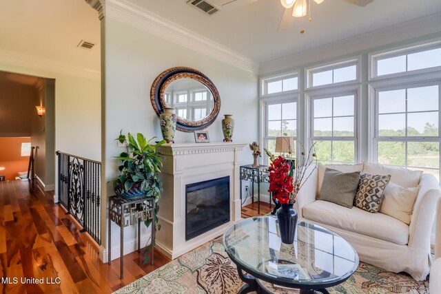 13129 Jordan Bluff Rd, Kiln, MS 39556 - living area featuring ornamental molding, a ceiling fan, plenty of natural light, wood finished floors, and baseboards