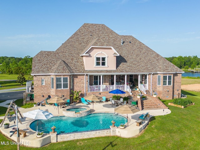 13129 Jordan Bluff Rd, Kiln, MS 39556 - view of pool featuring a lawn, a patio, and a pool with connected hot tub