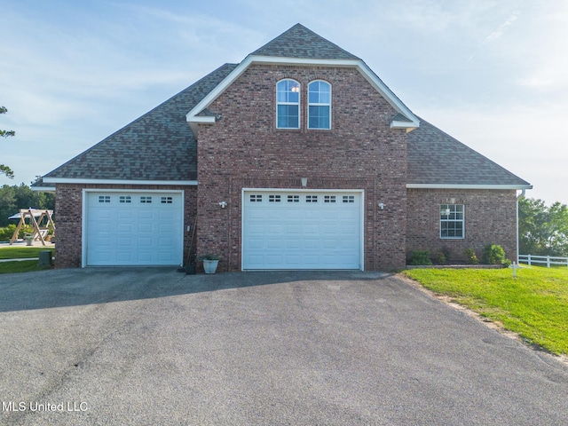 13129 Jordan Bluff Rd, Kiln, MS 39556 - view of front facade with driveway, brick siding, a shingled roof, and fence