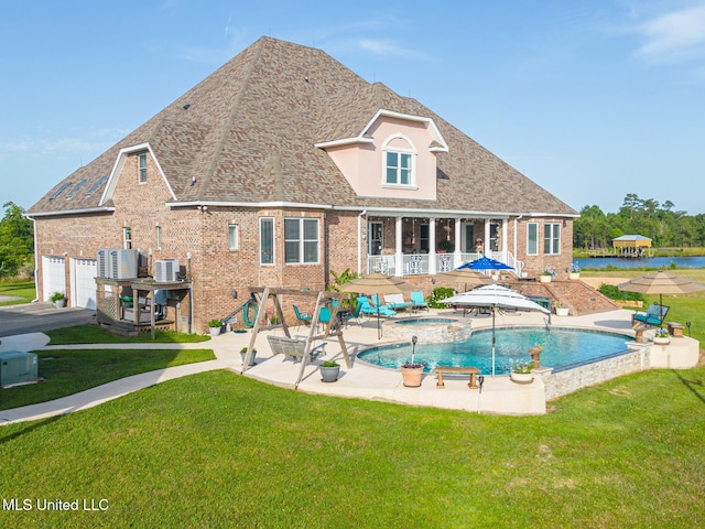 13129 Jordan Bluff Rd, Kiln, MS 39556 - view of swimming pool with a yard, a patio area, central AC unit, and a pool with connected hot tub