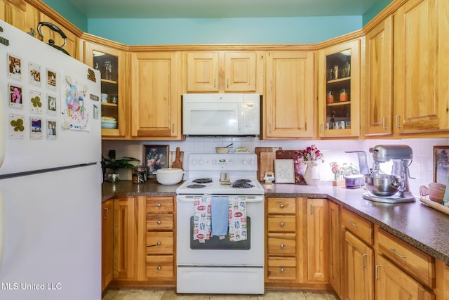 13129 Jordan Bluff Rd, Kiln, MS 39556 - kitchen featuring white appliances, dark countertops, decorative backsplash, and glass insert cabinets