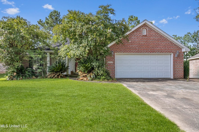 view of front of house with a front yard and a garage