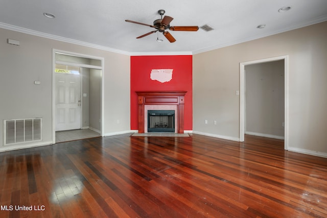 unfurnished living room with crown molding, a tile fireplace, dark hardwood / wood-style floors, and ceiling fan