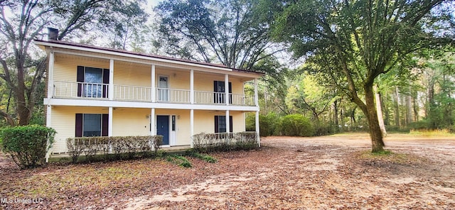 view of front of home with a porch and a balcony