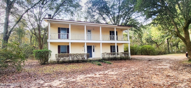 front of property with covered porch and a balcony