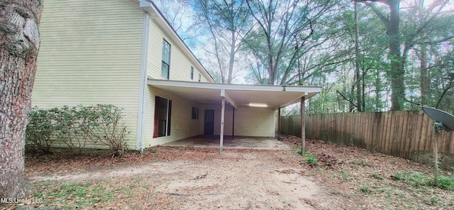 view of side of home featuring a carport