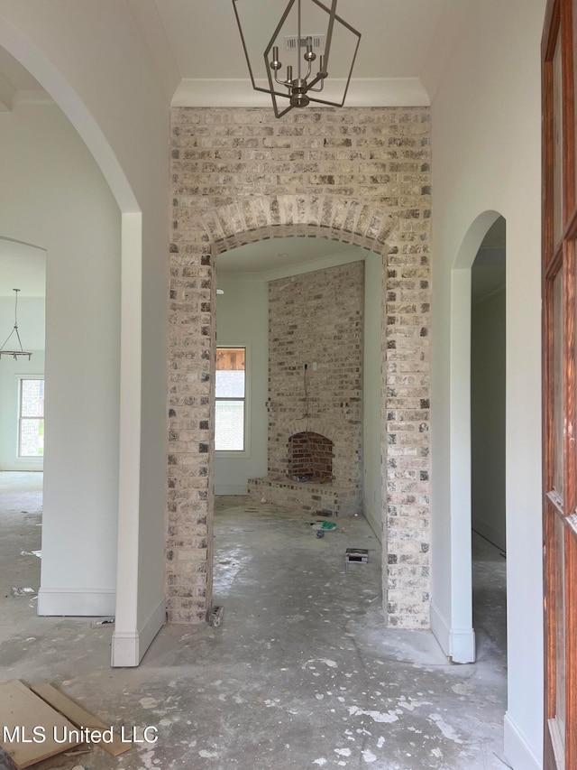 interior space with a notable chandelier and crown molding